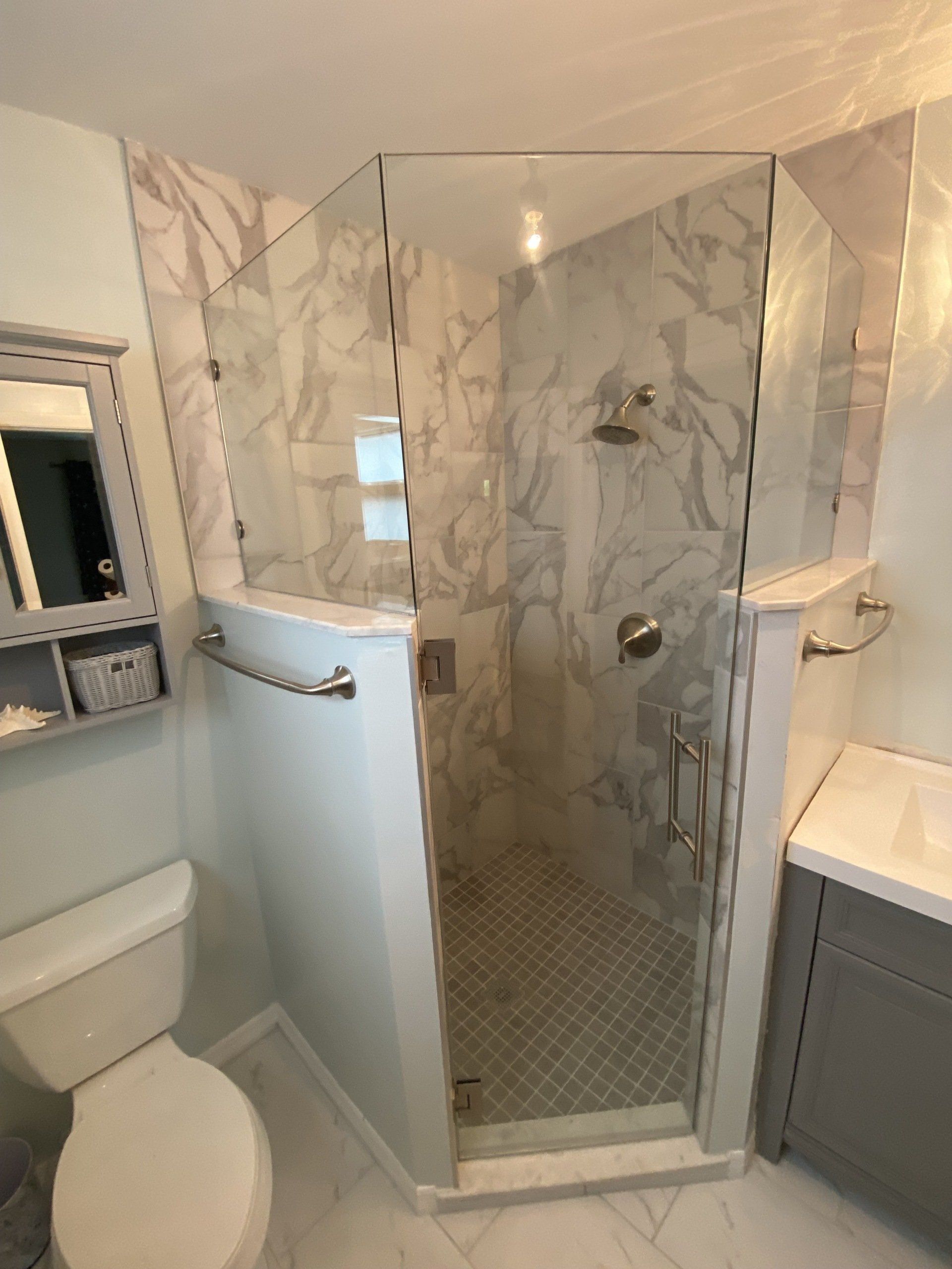 Frameless shower enclosure