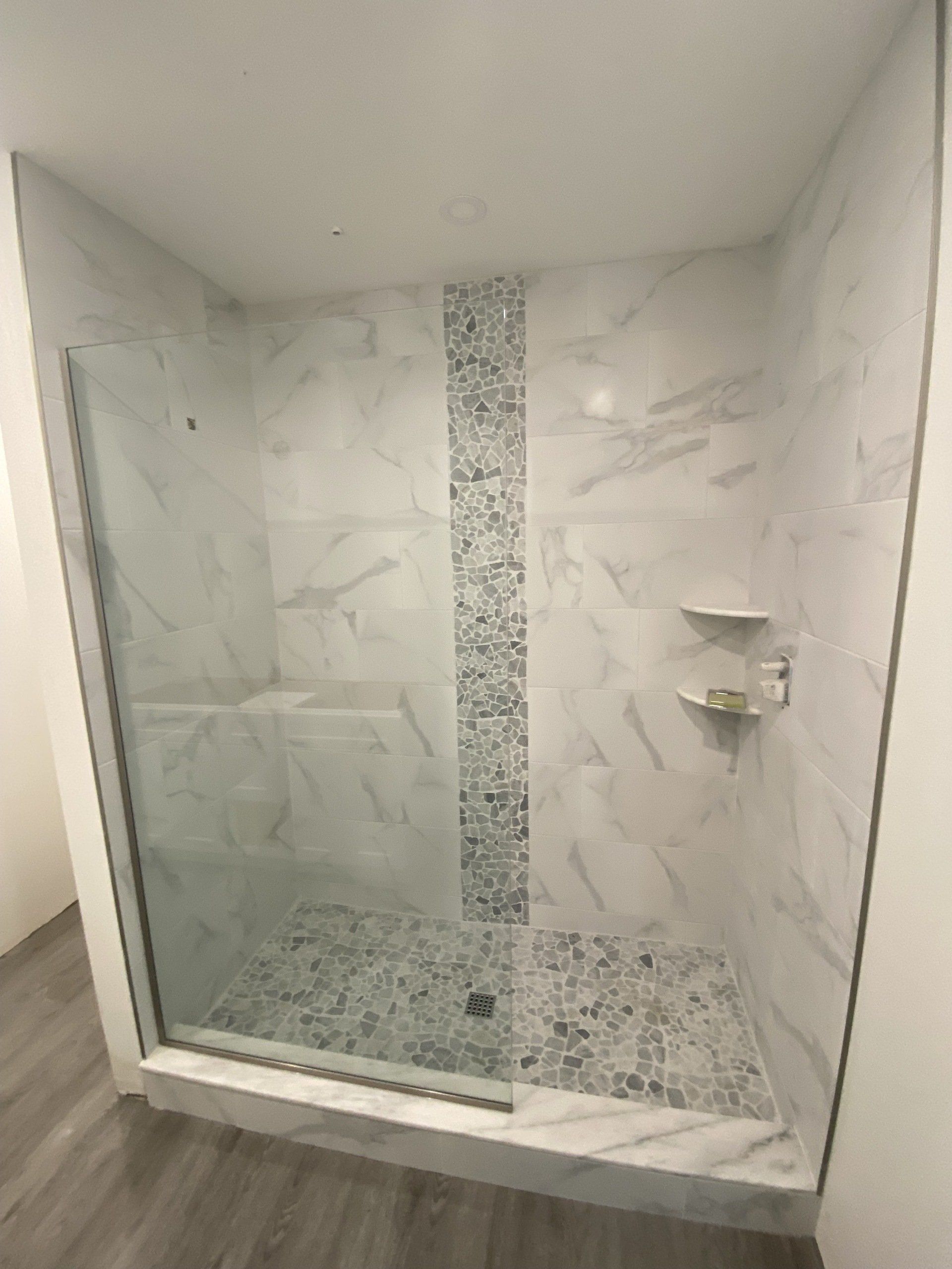 Frameless shower enclosure