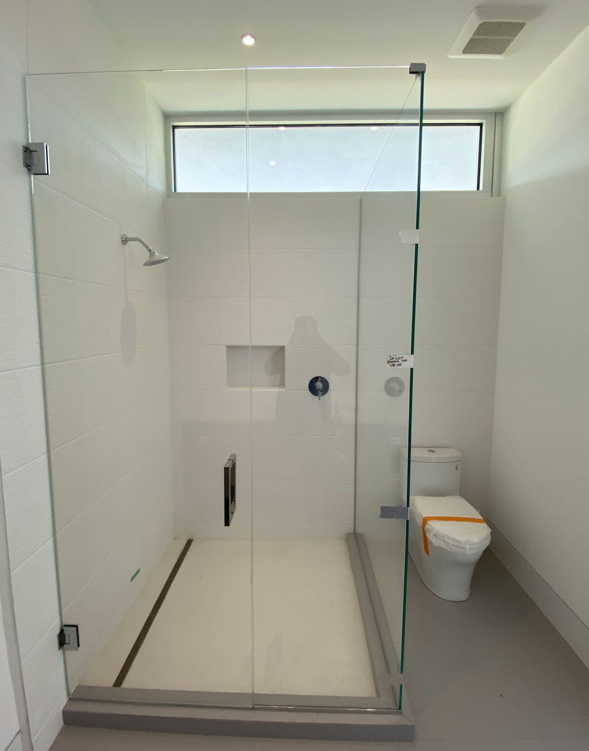 Frameless shower enclosure