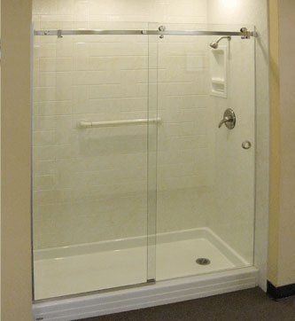 Frameless shower enclosure
