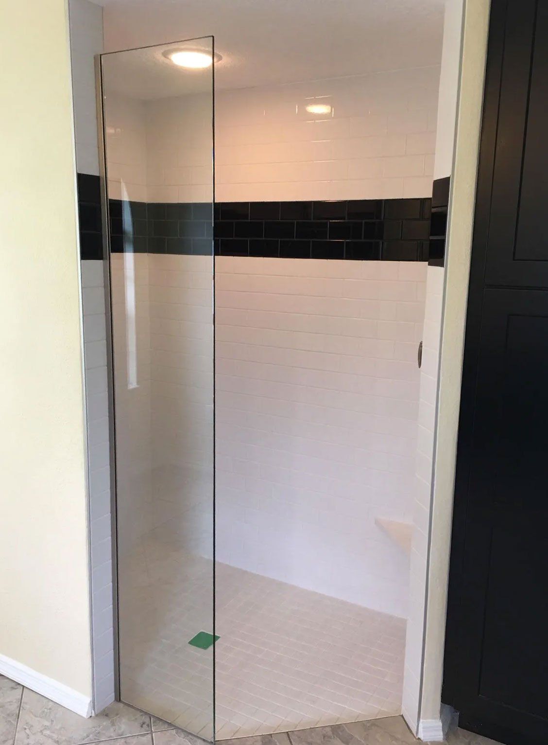 Frameless shower enclosure