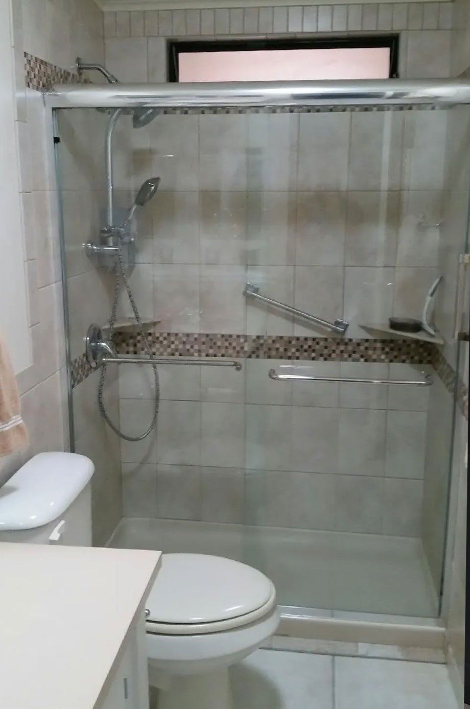 Frameless shower enclosure