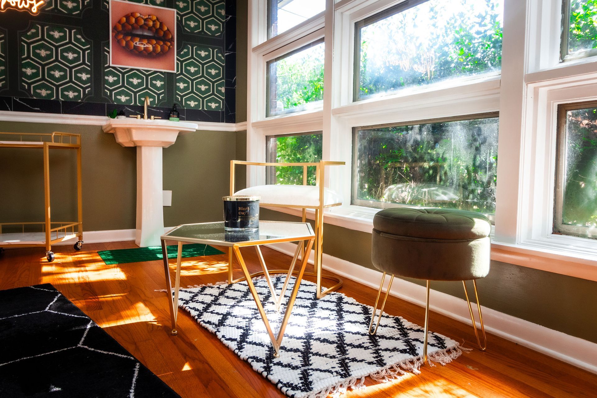 A room with a lot of windows and a rug on the floor.