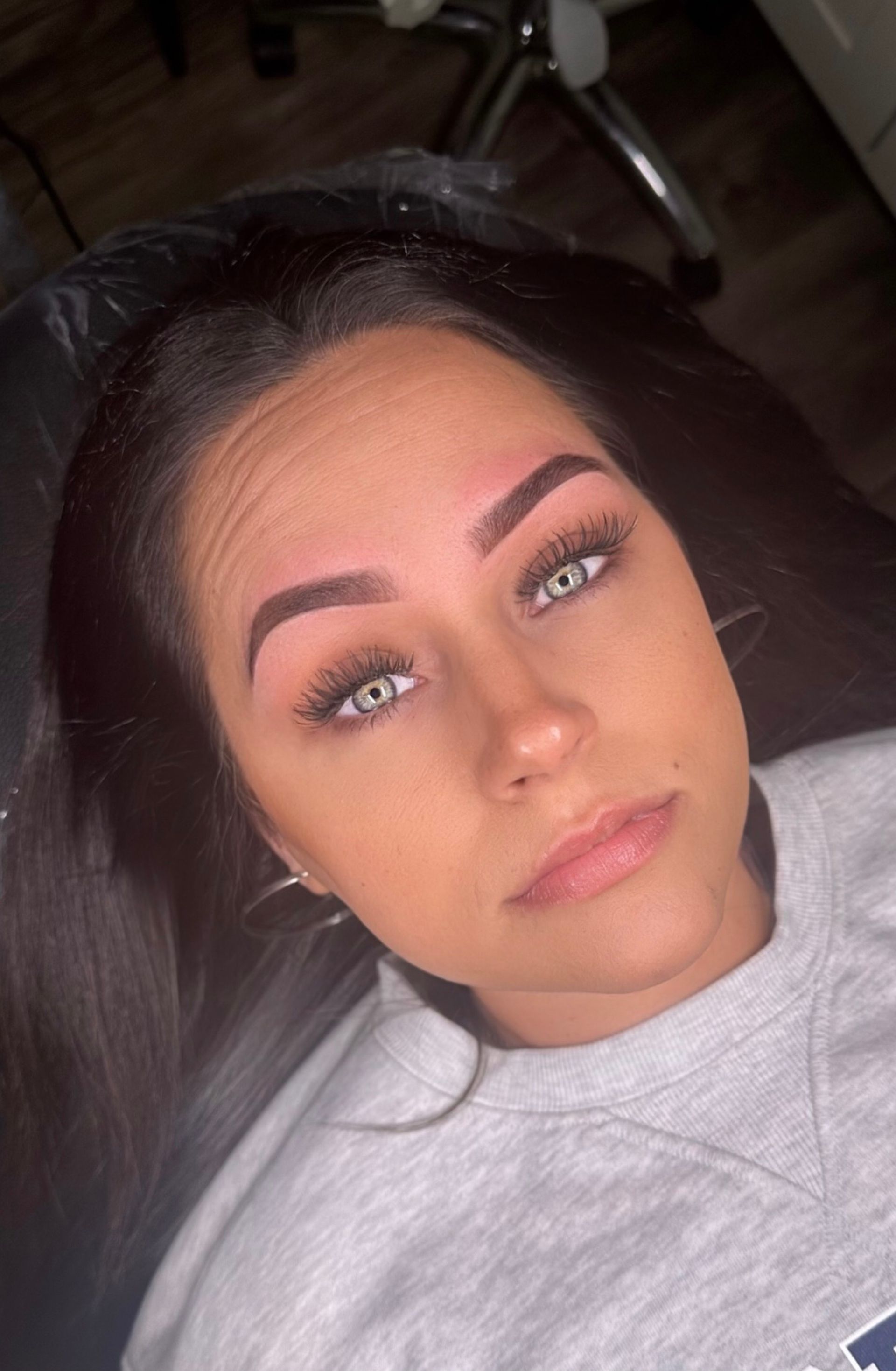 A woman is laying in a chair