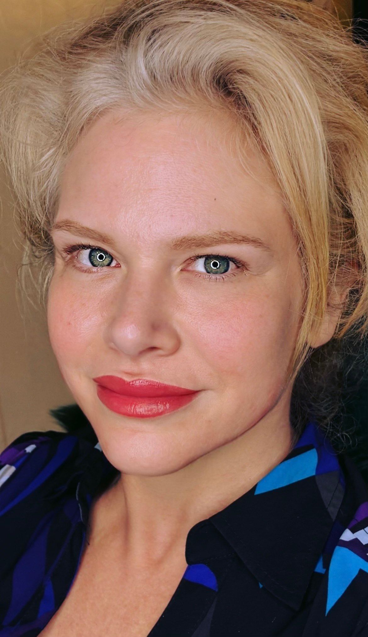A close-up of a woman's face with red lipstick