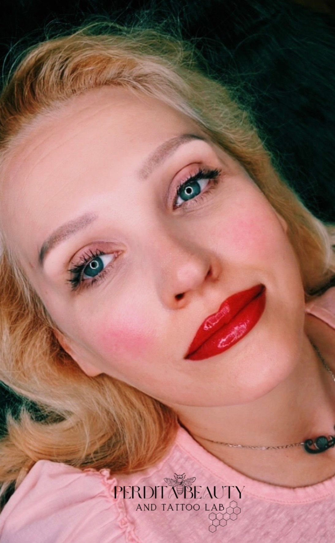 A close-up of a woman's face with red lips.