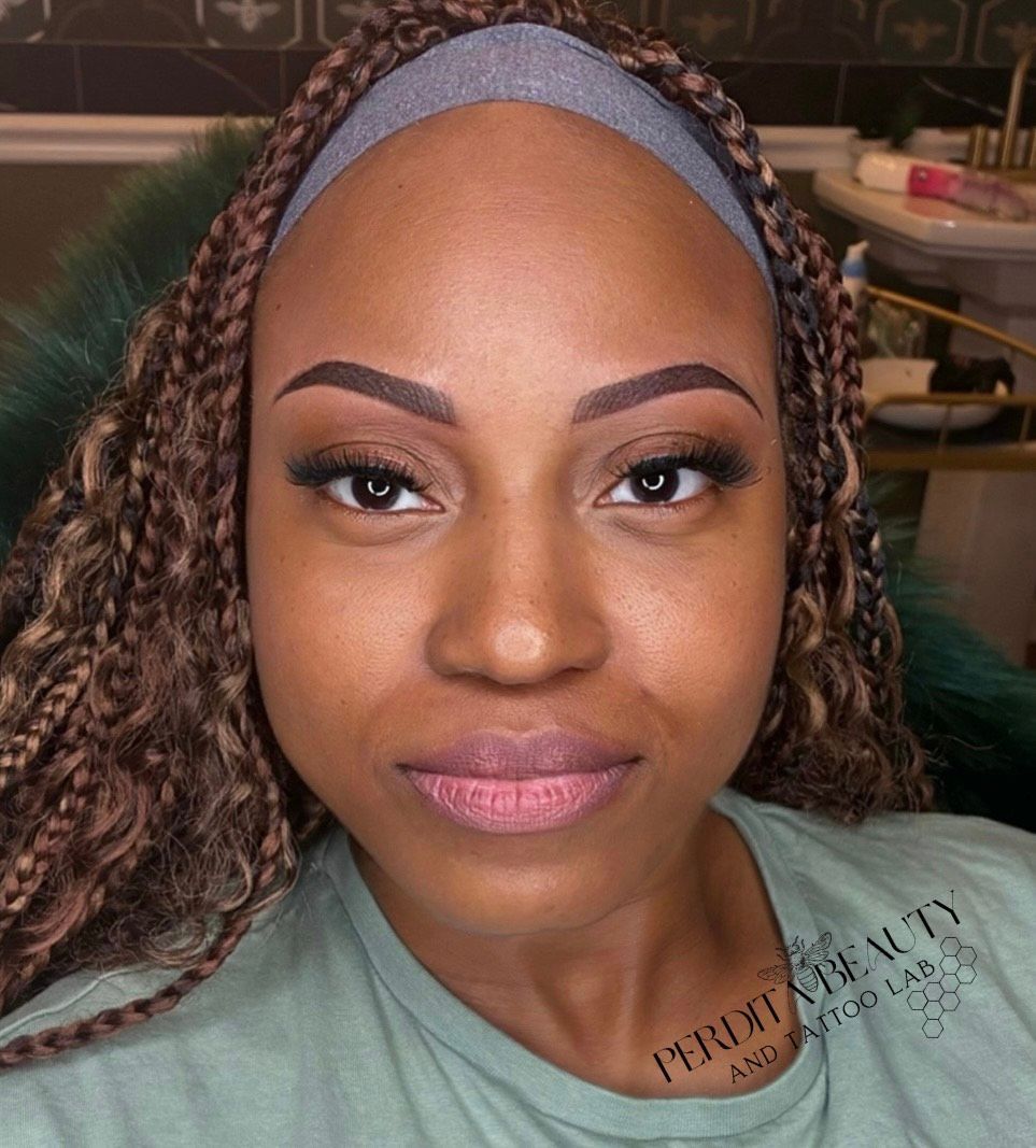 A close-up of a woman's face with braids and a headband.