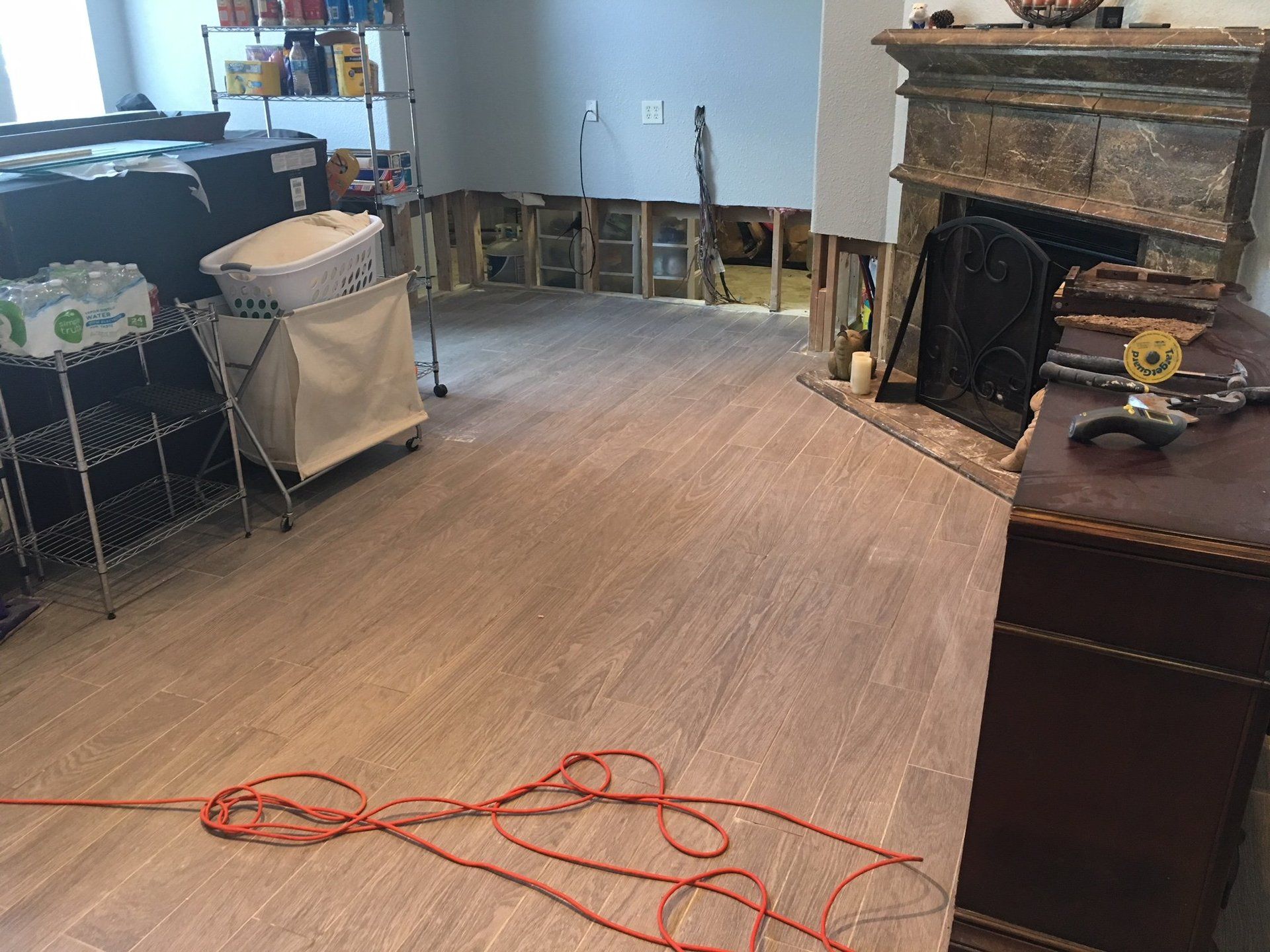 A living room with hardwood floors and a fireplace.