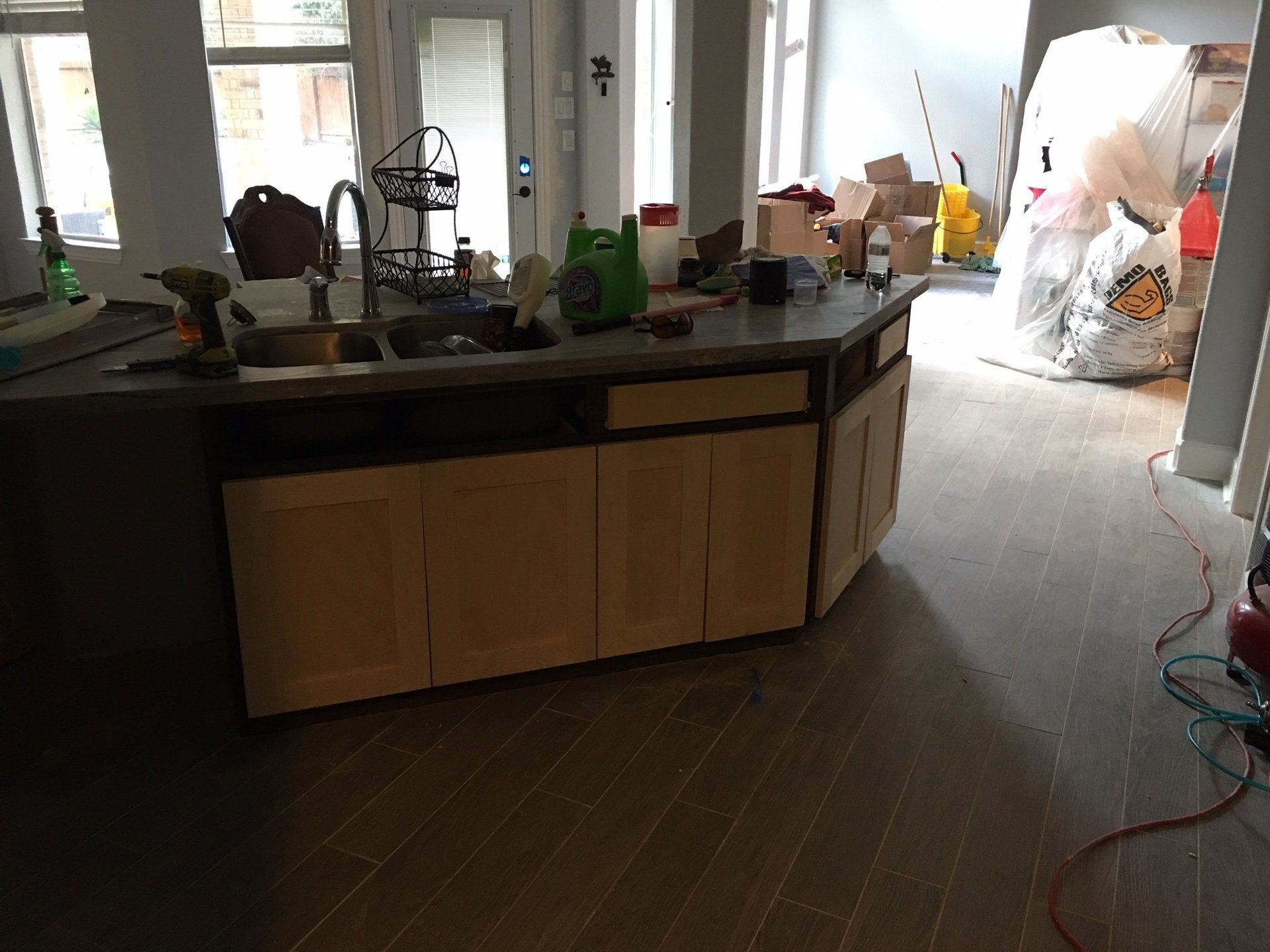 A kitchen with a sink and cabinets is being remodeled