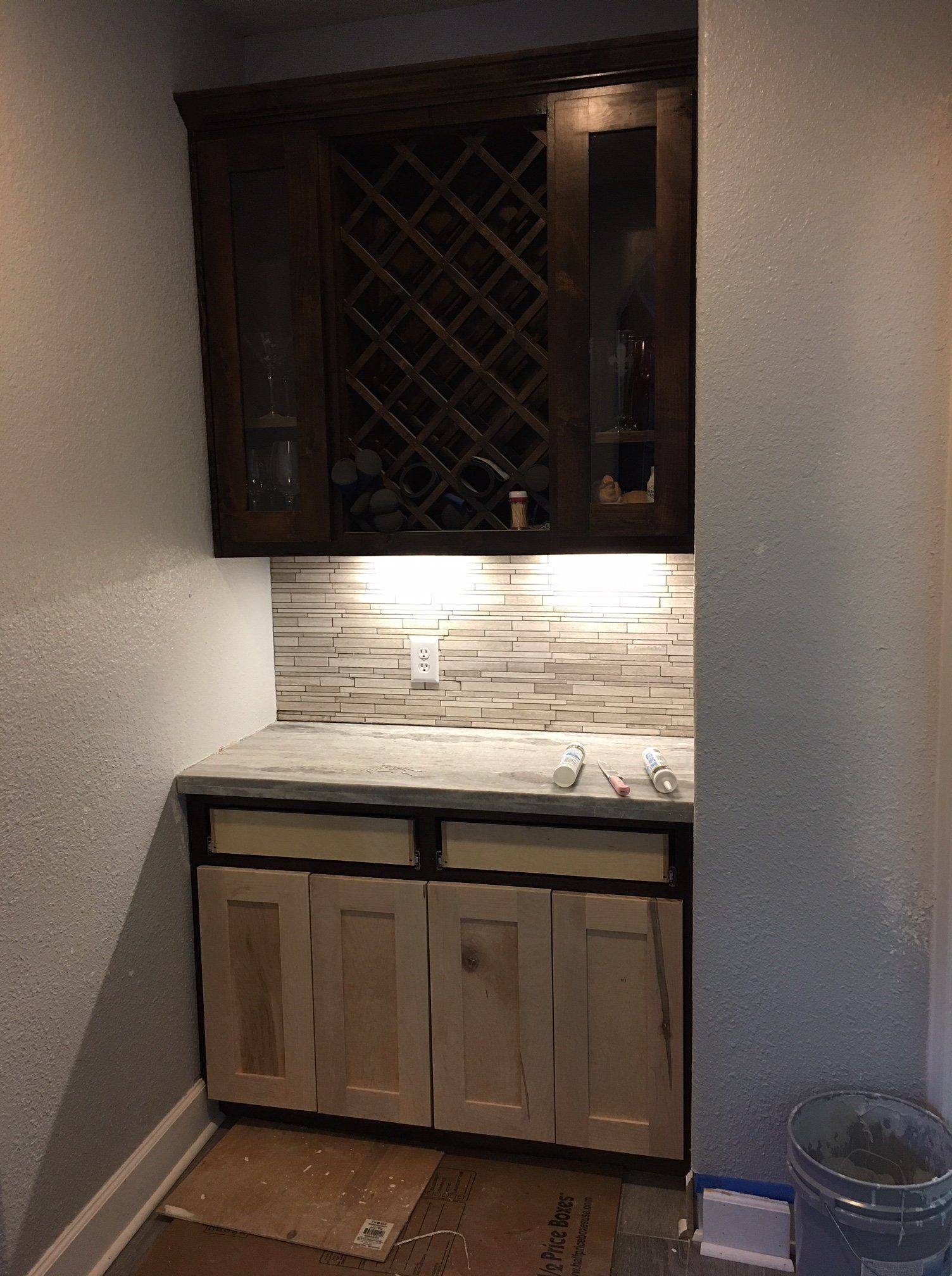A kitchen with a wine rack and a sink.