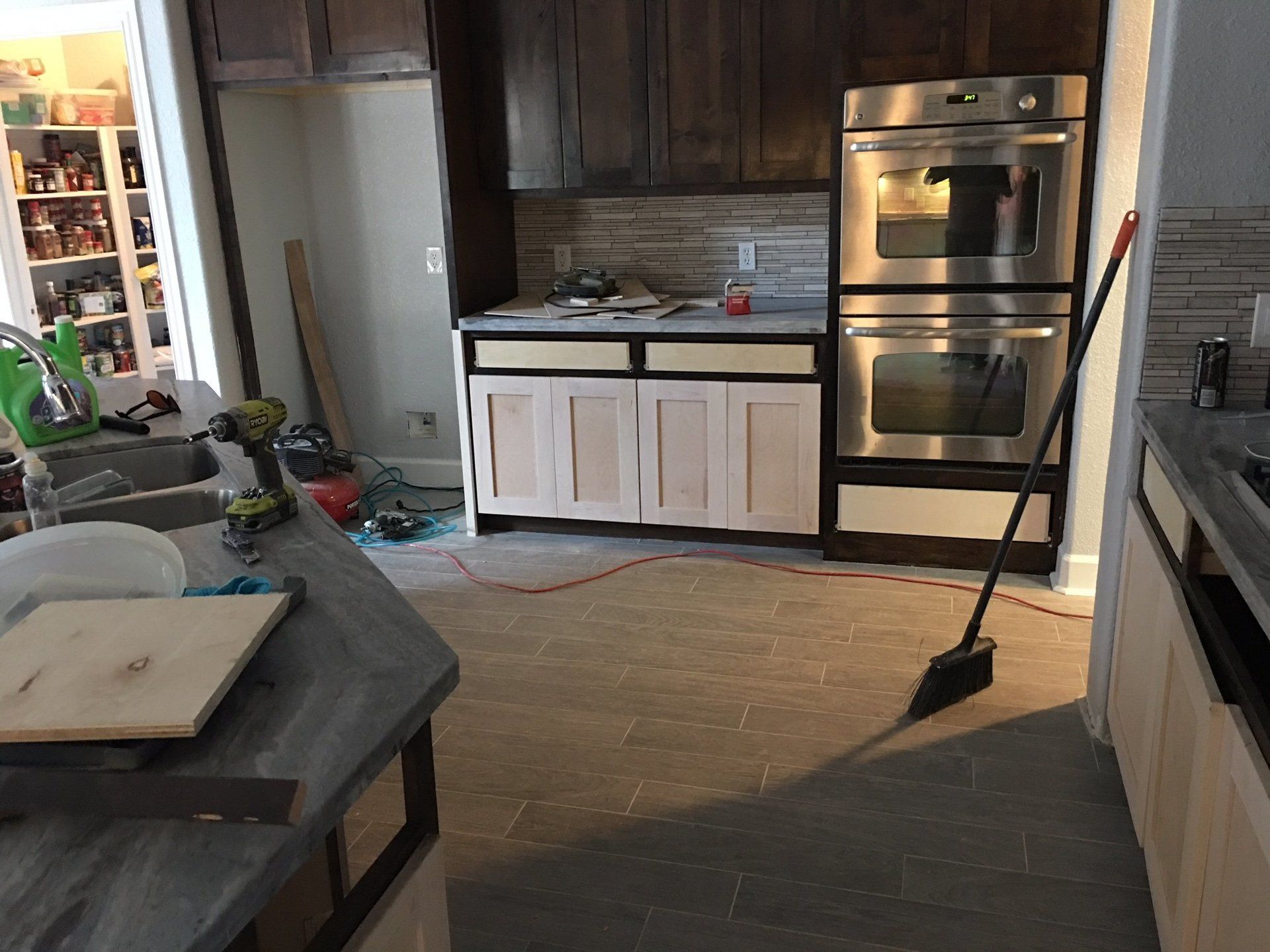 A kitchen with stainless steel appliances and wooden cabinets