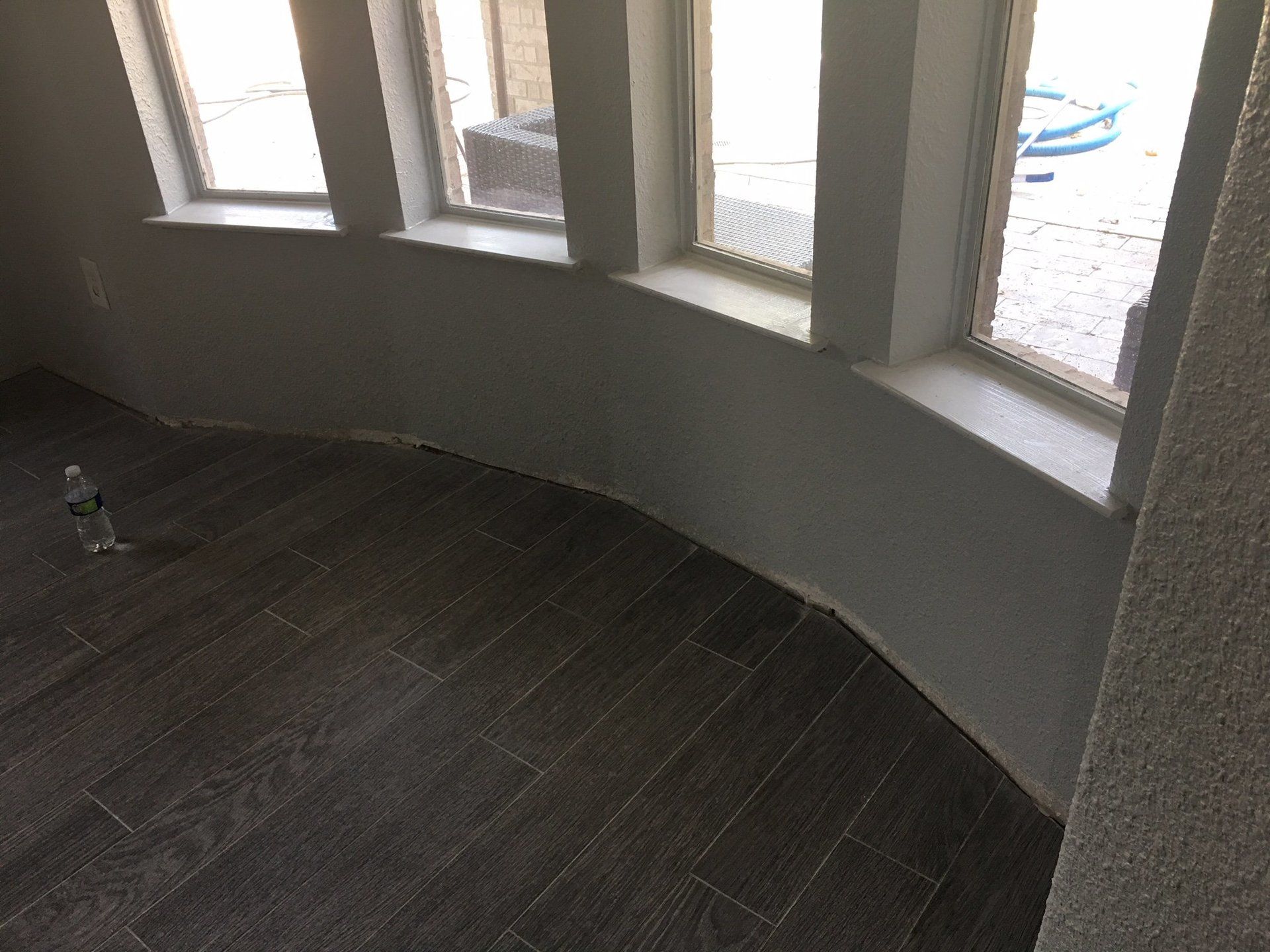 A room with a curved wall and a lot of windows