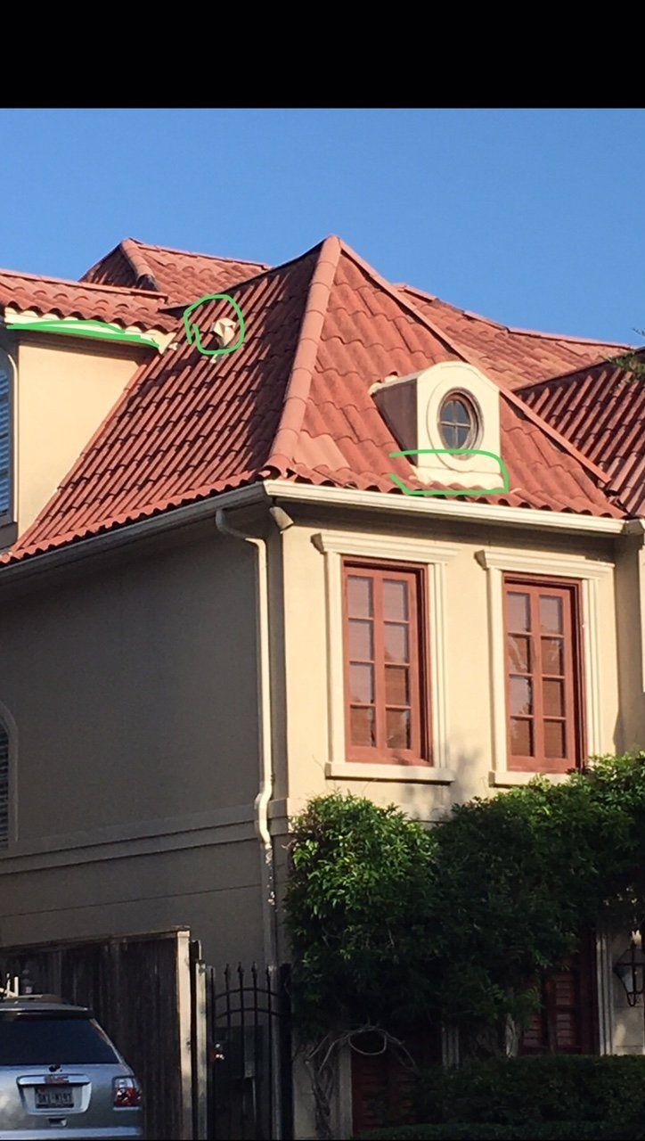 A house with a red tile roof and two windows