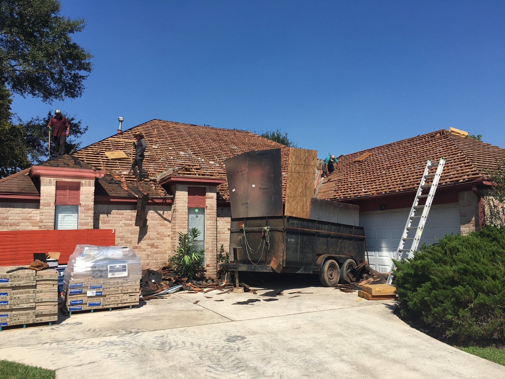 A trailer is parked in front of a house that is being remodeled.
