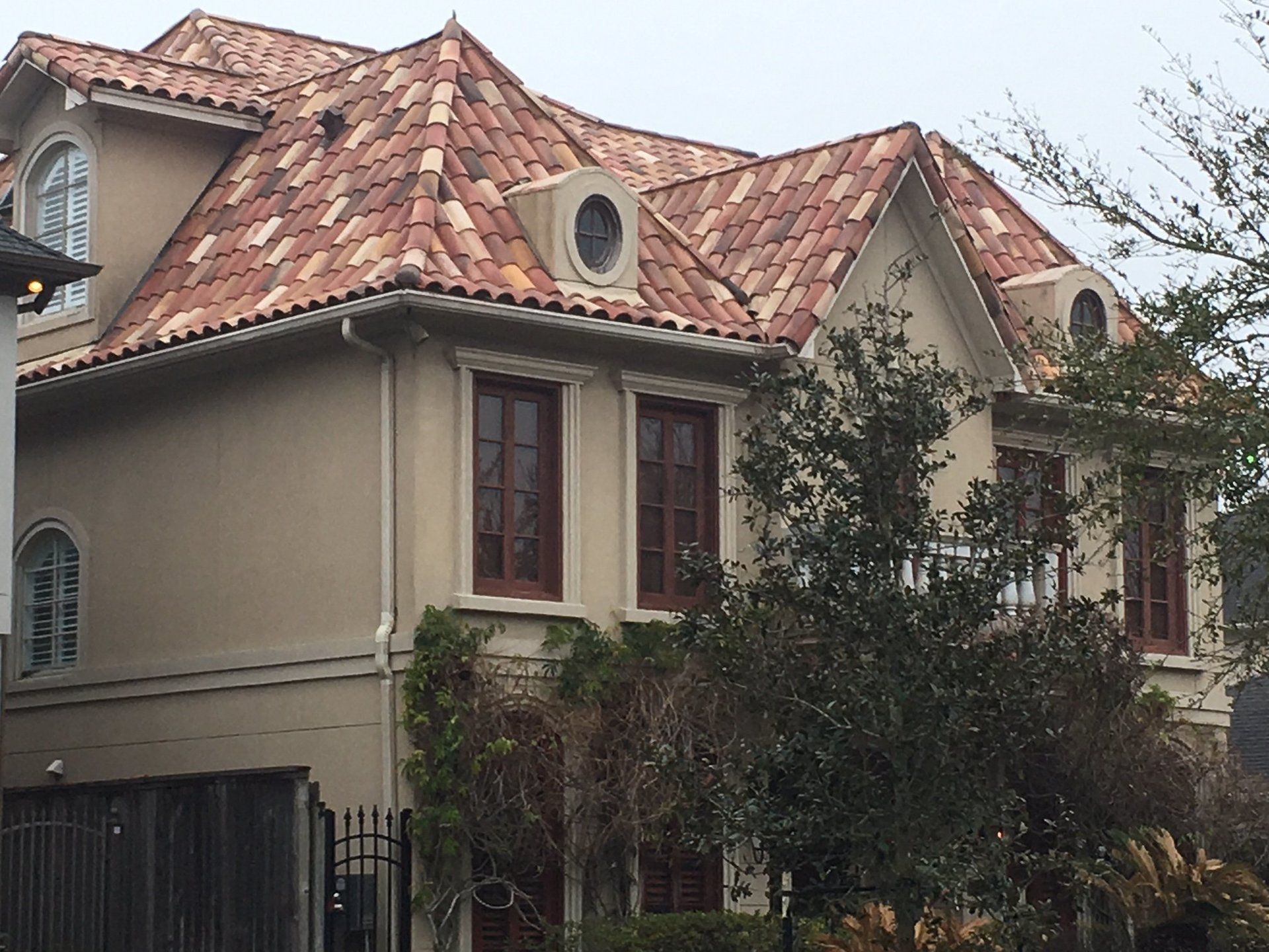 A large house with a tiled roof and a lot of windows