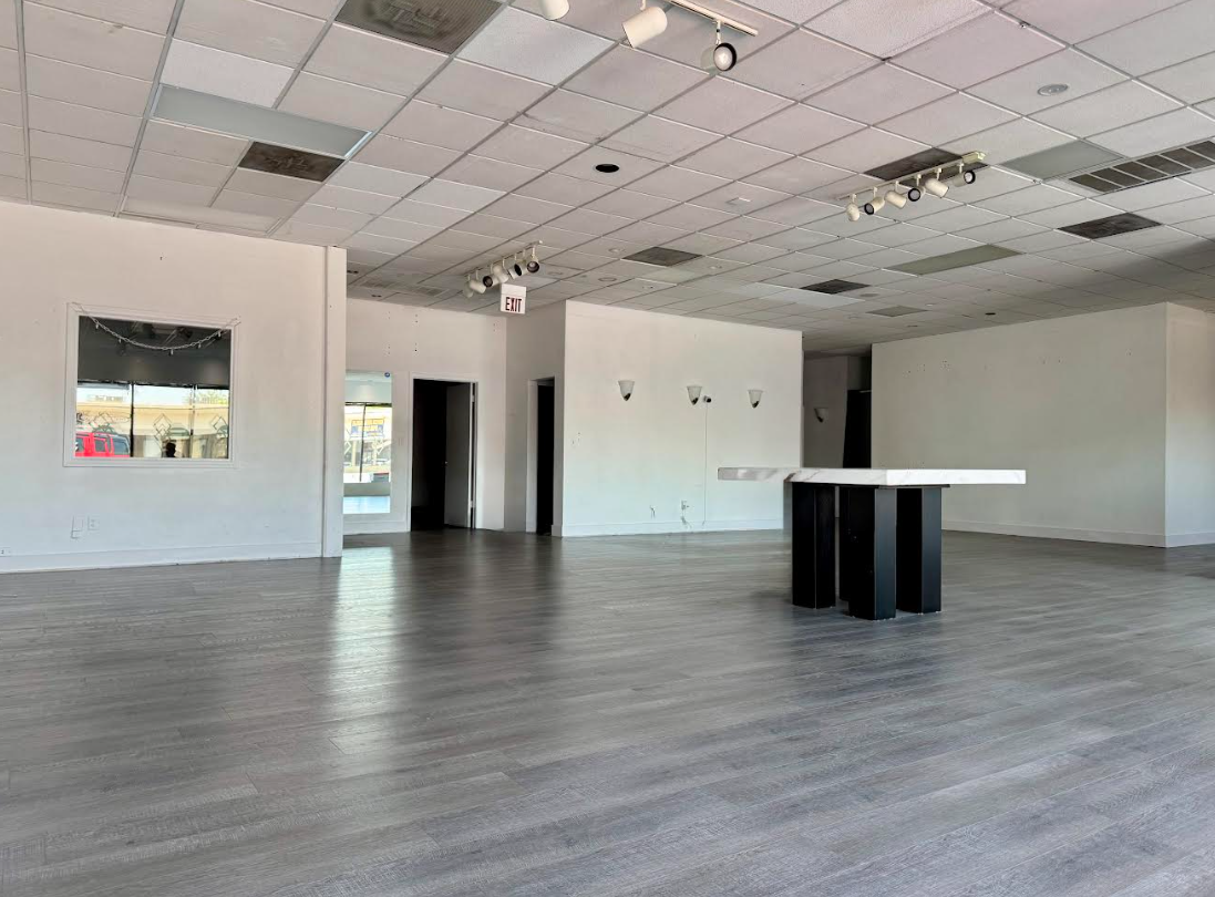 A large empty room with a table in the middle of it