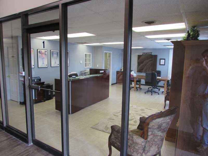 A reflection of a man in a mirror in a glass doorway