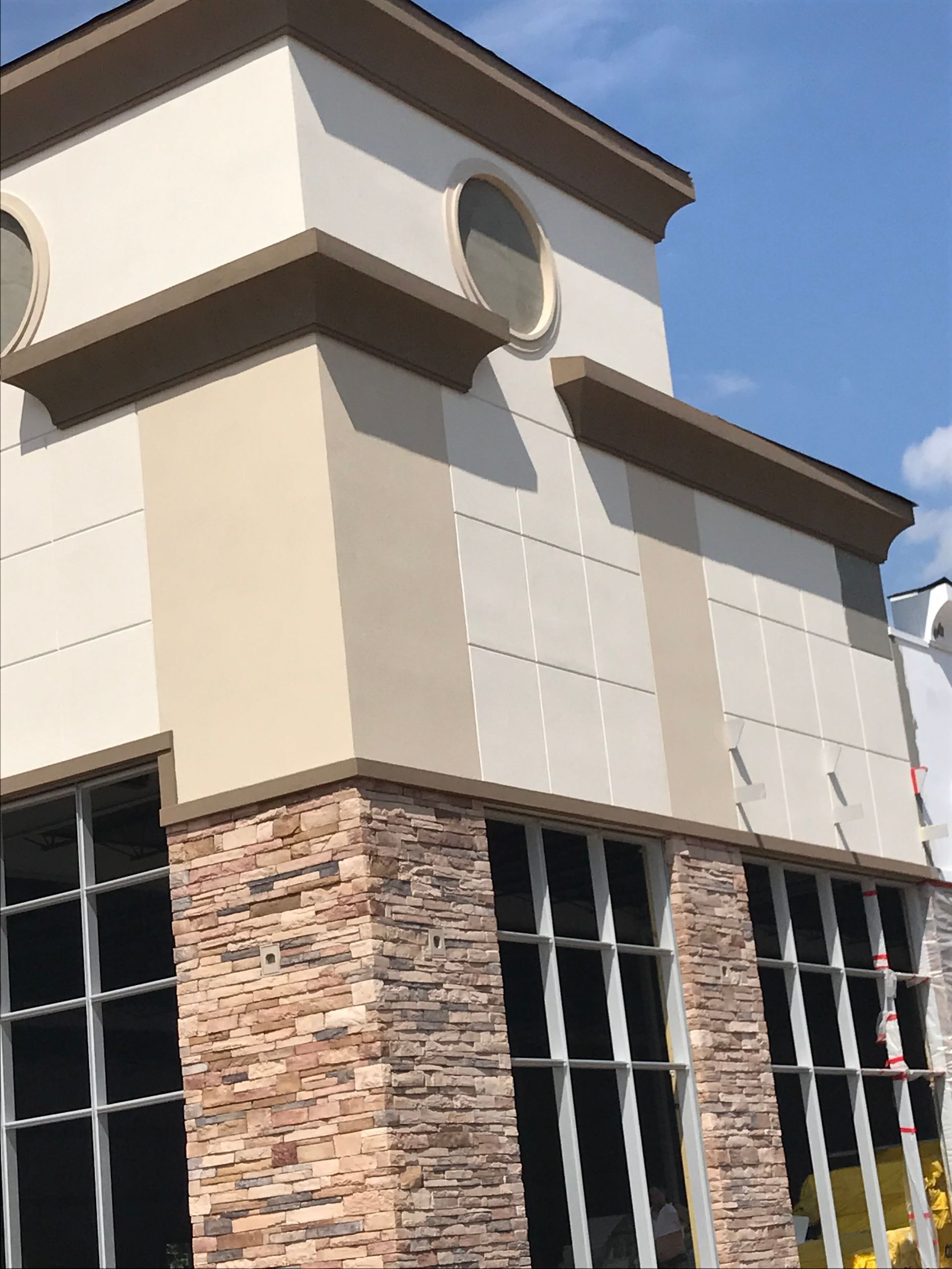 A large building with a lot of windows and a blue sky in the background