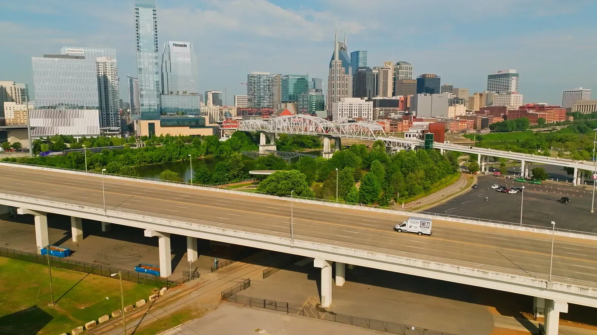 Nashville skyline view from a bridge on a sunny day.