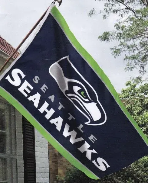 Seattle Seahawks flag with team logo and text, green and blue.