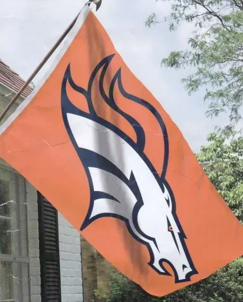Denver Broncos flag with white horse head logo on orange background.