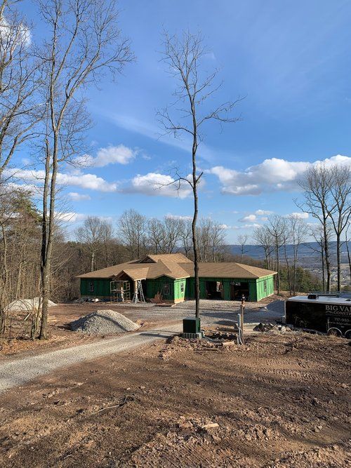 A house is being built in the middle of a forest.