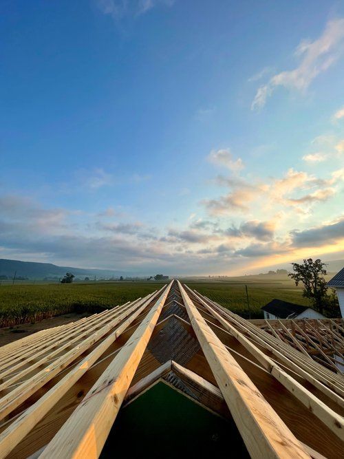 A roof under construction with a blue sky in the background