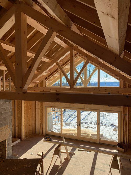A room with a lot of wooden beams and windows