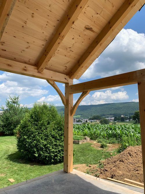 A wooden structure with a view of a field in the background
