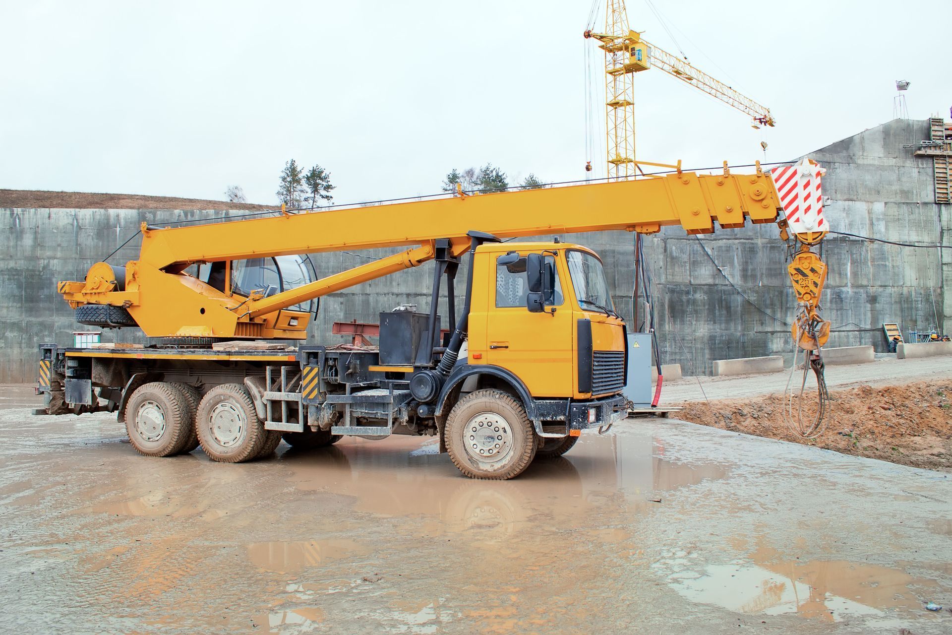 Yellow mobile crane on construction site.