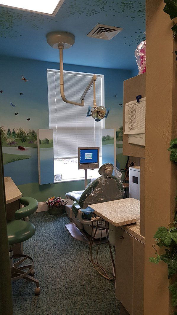 a dental office with a painting of a river on the wall