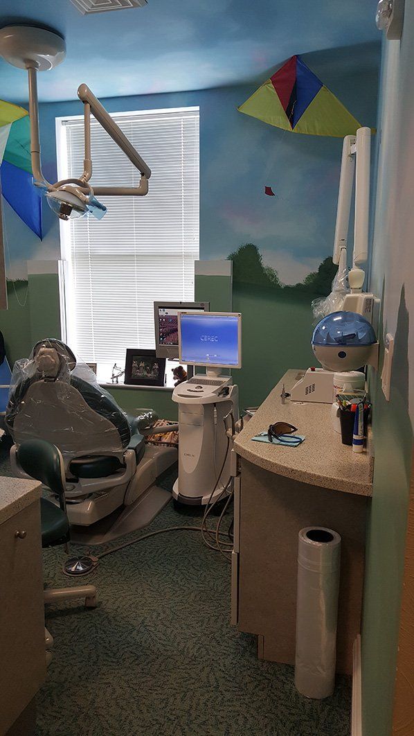 a dental office with a mural on the wall