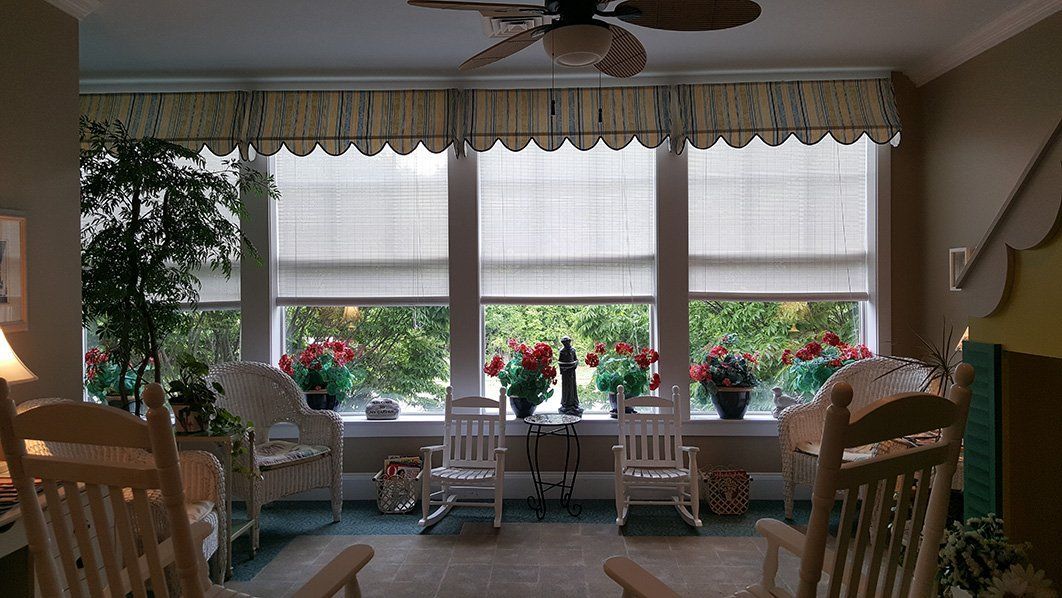 a room with rocking chairs and a ceiling fan