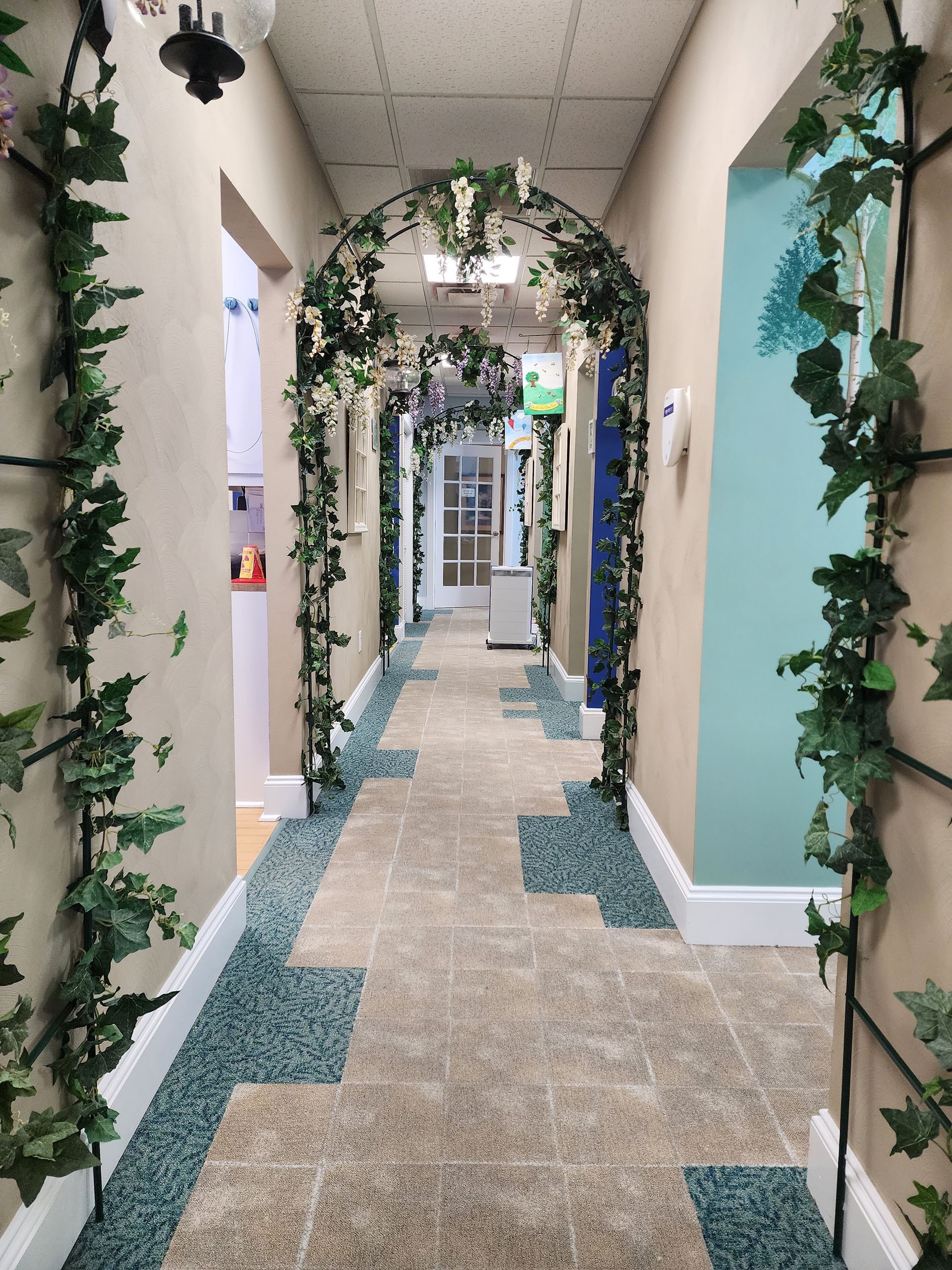 a hallway decorated with ivy and flowers 