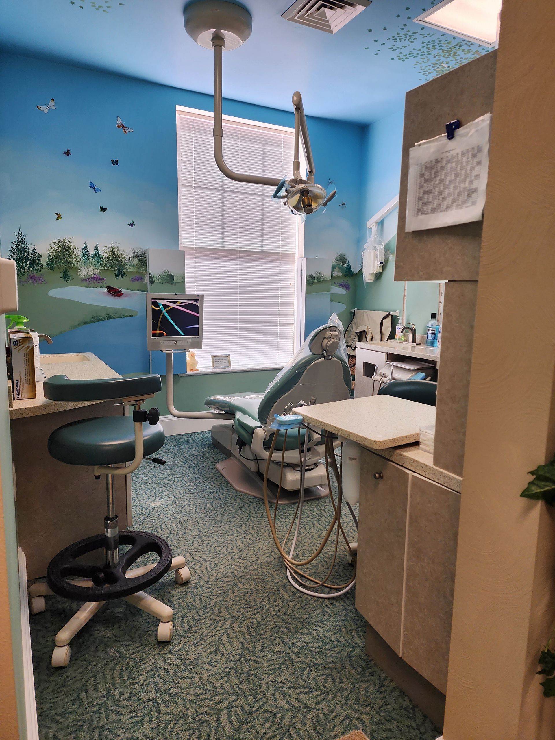 a dental office with a painting of a lake