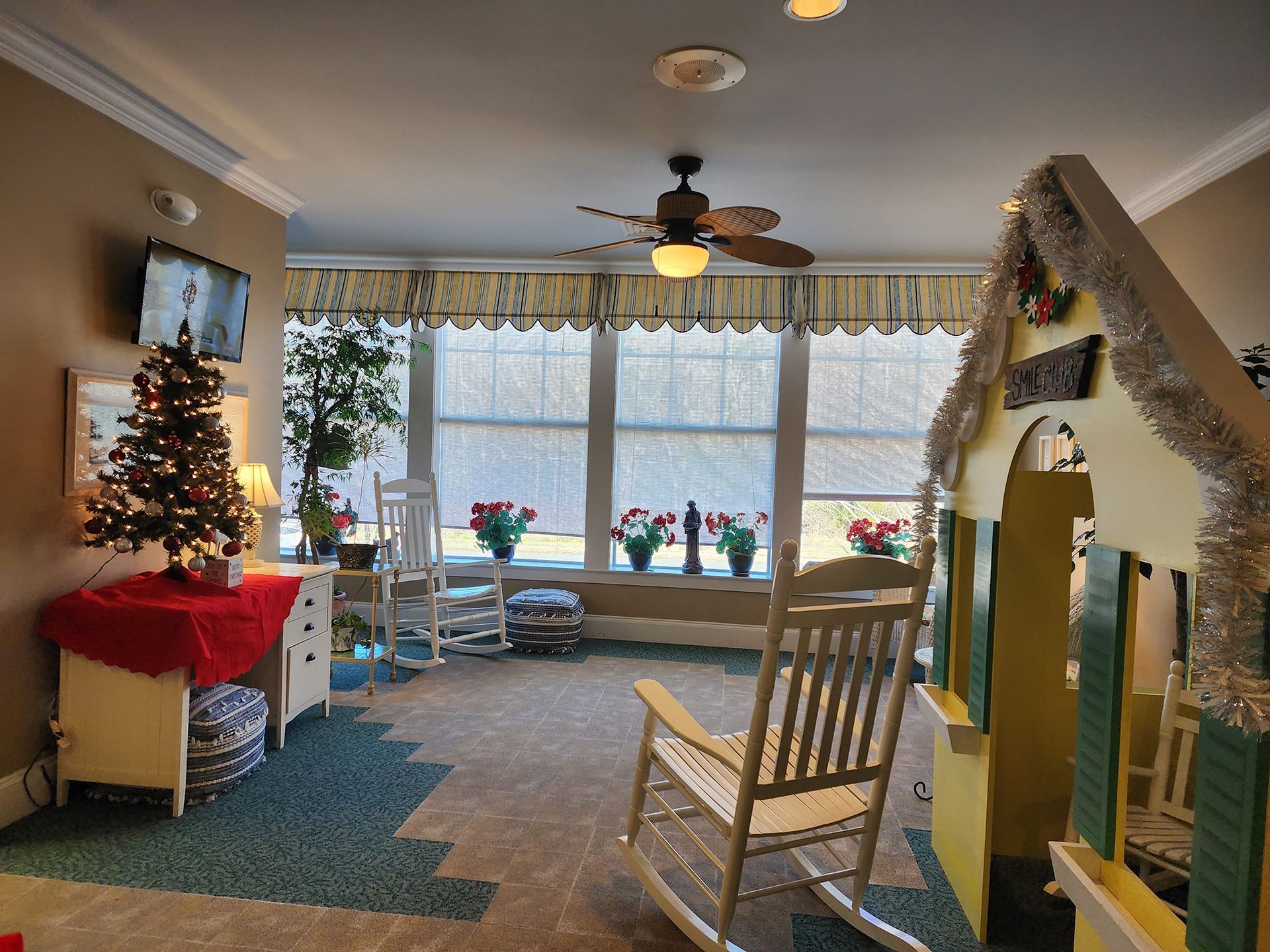 a room with rocking chairs and a play house