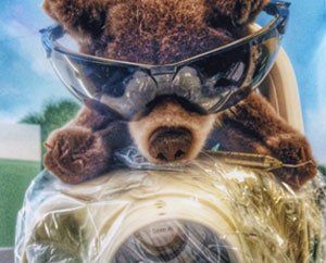 a stuffed animal is wearing a gas mask and goggles