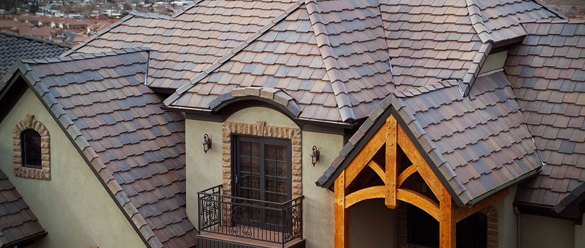 Roof with gray shingles and two dormer windows on a house exterior