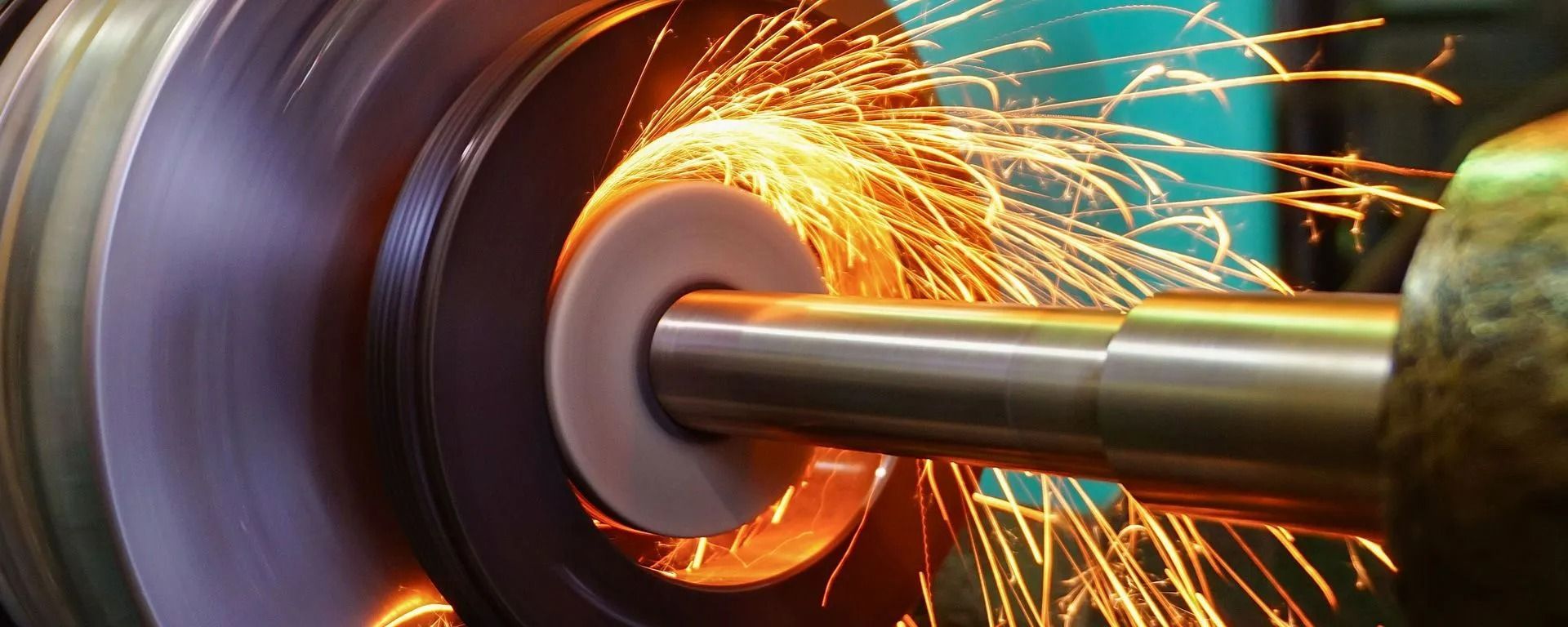 Grinding wheel cutting metal, throwing bright orange sparks