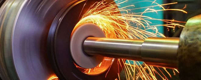 Grinding wheel cutting metal, throwing bright orange sparks
