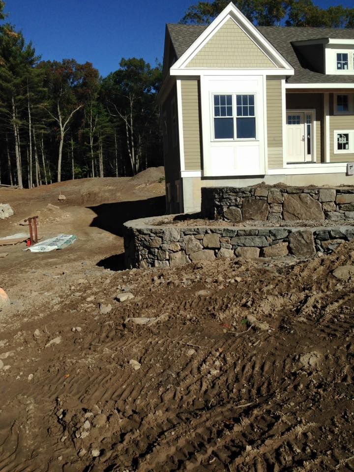 A house is being built in the middle of a dirt field