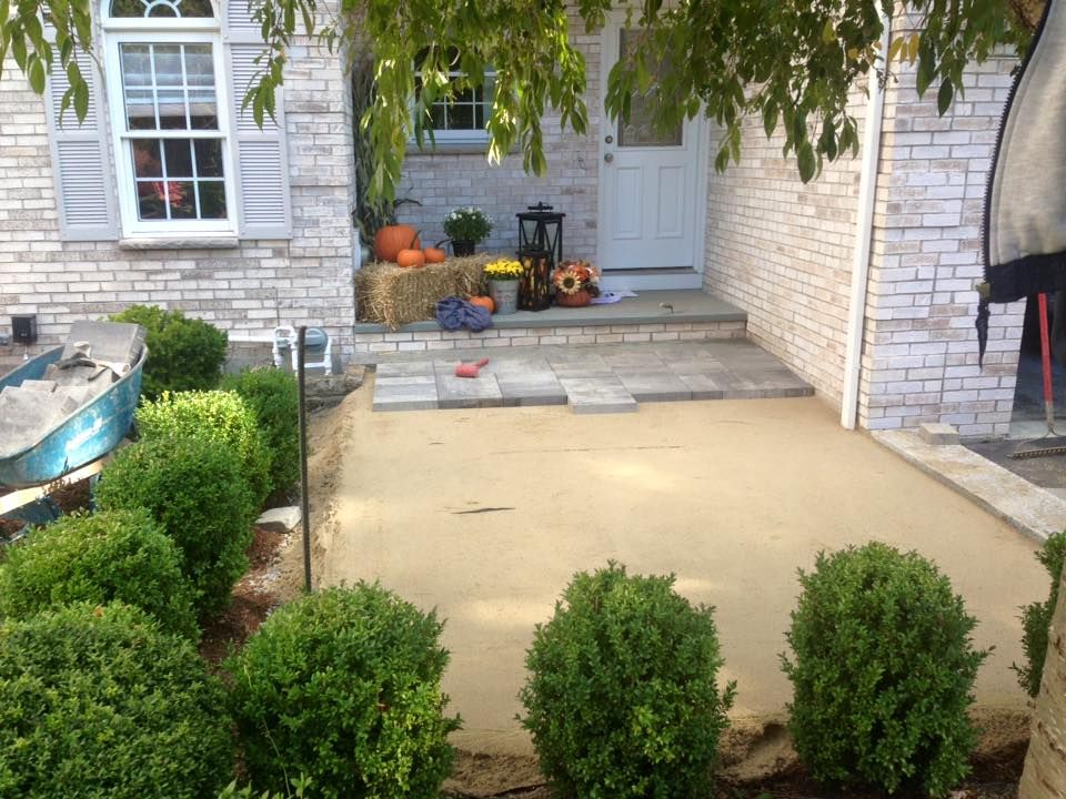 A brick house with a patio in front of it.