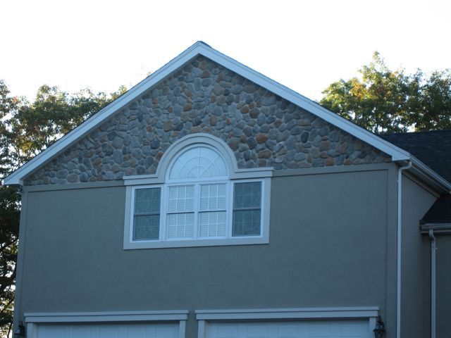 A house with a stone roof and a window