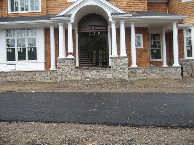 A large brick house with a porch and columns