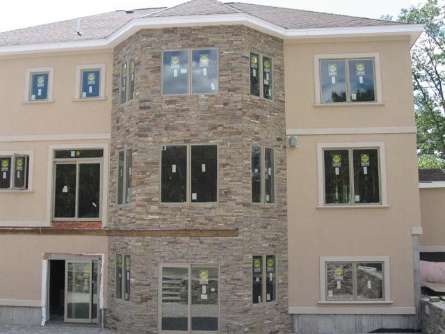 A large house with a lot of windows is under construction