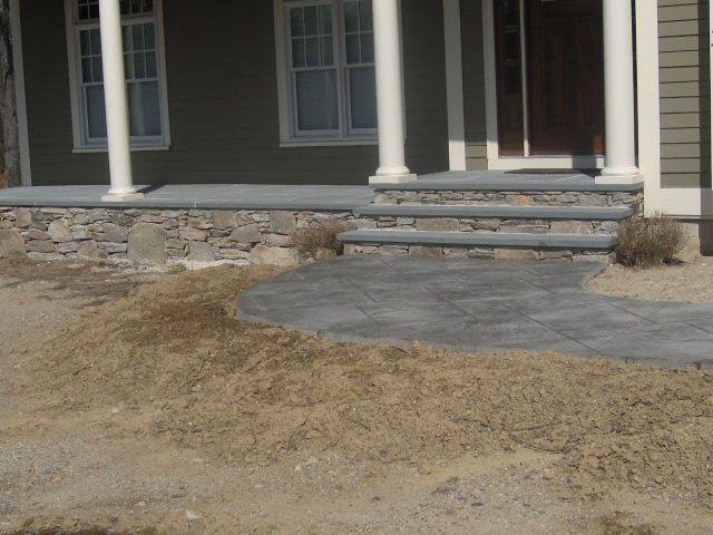 A house with a stone walkway leading to the front door