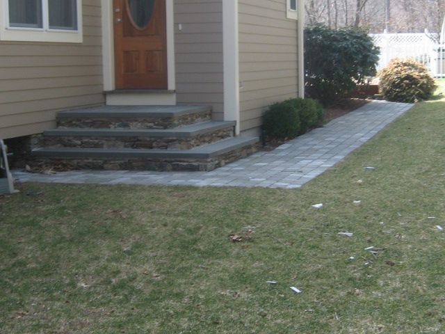 A house with a walkway leading to the front door