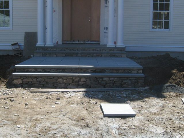 A house with stone steps leading up to the front door