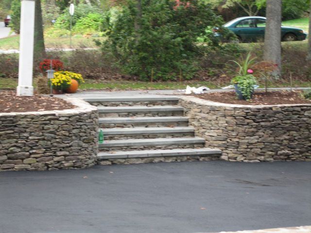 A stone wall with stairs leading up to it