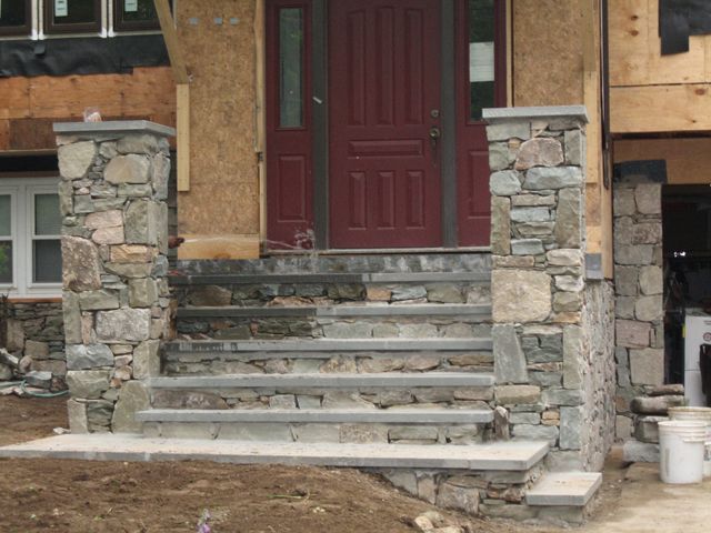 A house with a red door and stone steps